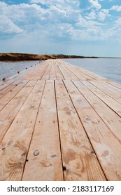 Wooden jetty at sea shore. Wooden jetty sticking out into water. Jetty or pier natural background.