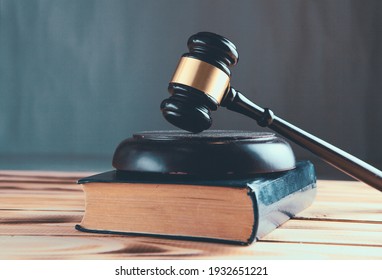 Wooden judge gavel and law books.