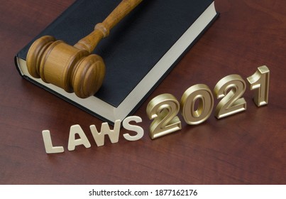 Wooden Judge Gavel, Legal Book And Numbers 2021. Concept New Laws In Year 2021.	