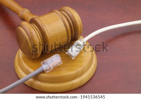 Wooden judge gavel and two disconnected computer cables close up. Law and internet concept.  [[stock_photo]] © 