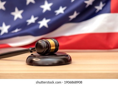 Wooden judge gavel USA flag as background, concept picture about justice in the USA - Powered by Shutterstock