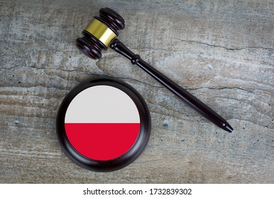 Wooden Judgement Or Auction Mallet With Of Poland Flag. Conceptual Image.