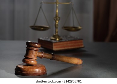 Wooden Judges Gavel And Symbol Of Law And Justice On Table In A Courtroom Or Law Enforcement Office On Dark Background