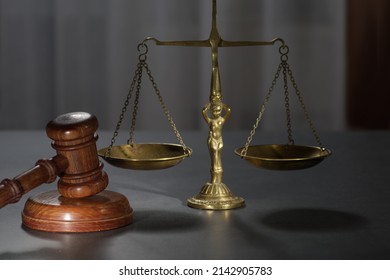 Wooden Judges Gavel And Symbol Of Law And Justice On Table In A Courtroom Or Law Enforcement Office On Dark Background