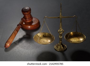 Wooden Judges Gavel And Symbol Of Law And Justice On Table In A Courtroom Or Law Enforcement Office On Dark Background