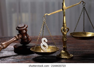 Wooden Judges Gavel And Symbol Of Law And Justice On Table In A Courtroom Or Law Enforcement Office On Dark Background