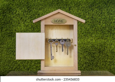 Wooden Key Holder House with  isolated white background.Property insurance and security concept .