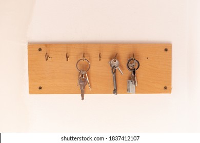 Wooden Key Holder On Bright Wall, Close Up