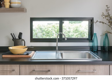 Wooden Kitchen Counter With Black Granite On Top And Sink