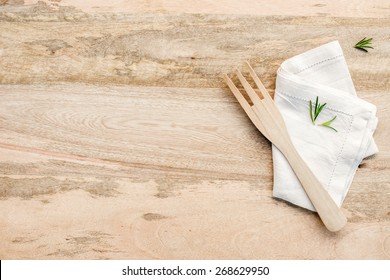 Wooden Kitchen Table From Above With Copy Space. Rosemary On Wood Table. Kitchen Photo For Recipe Book Or Advertisement.