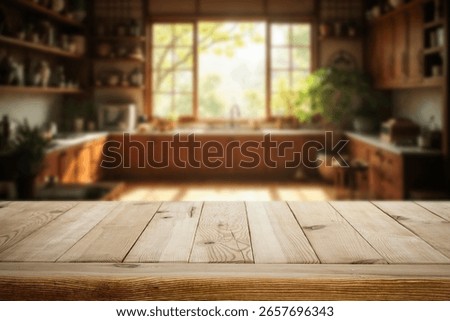 Wooden kitchen table with empty space for showcasing a product with blurred bright and cozy kitchen interior and warm sunlight streaming through a large window.