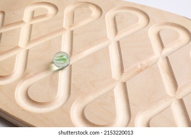 Wooden labyrinth balance board on white background, closeup. Montessori toy - Shutterstock ID 2153220013