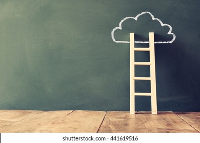 wooden ladder and cloud info graphics on blackboard background. retro filtered