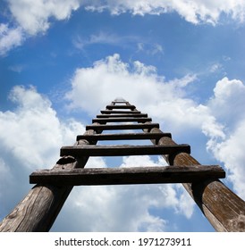 Wooden ladder leading high up in the heavenly looking blue sky and white clouds, success concept  - Shutterstock ID 1971273911