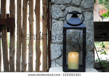 wooden lamp near wooden door and fence
