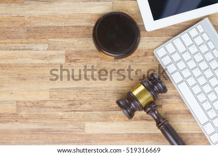 Wooden law gawel on wooden table with keyboard and tablet, judgement concept