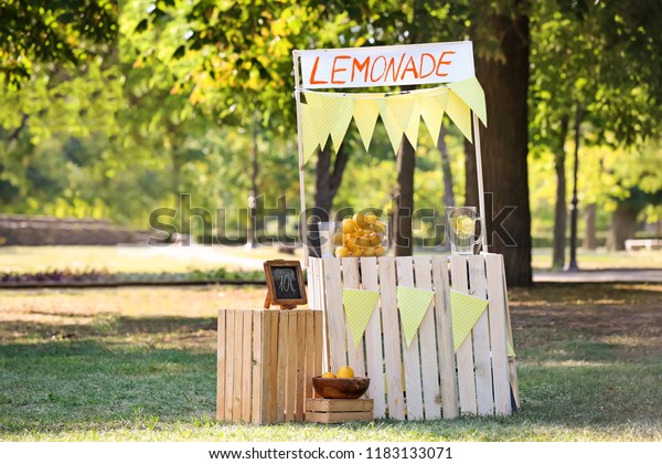 Wooden\
lemonade stand in park on sunny summer\
day