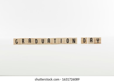 Wooden letter tiles that spell graduation day
