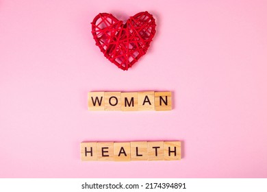 Wooden Lettering And Red Heart On Pink Background. Womens Health Concept.