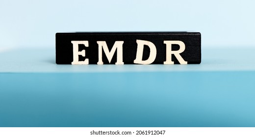 Wooden letters EMDR written on blue background. Eye Movement Desensitization and Reprocessing psychotherapy treatment concept. - Shutterstock ID 2061912047