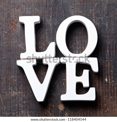 Wooden letters forming word LOVE written on wooden background