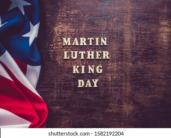 Wooden letters on a dark background. Martin Luther King Jr. Day. Top view, close-up. National holiday concept
