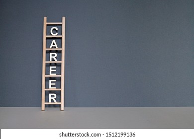 Wooden Letters On The Rungs Of A Ladder Spelling Out The Word Career. Climbing The Career Ladder Concept.