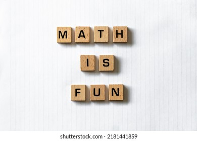 Wooden Letters Spell Out 'math Is Fun' On A Blank White Lined Notepad Beside A Red Apple And A Pen. Hardwood Desk Surface. Back To School, In-person Learning, Online Learning, Studying, No People.