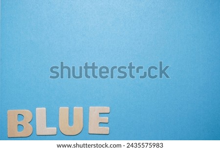 Wooden Letters Spelling Blue on a Blue background