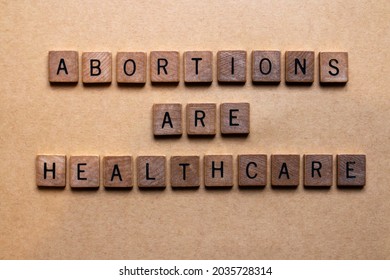 Wooden letters spelling out abortions are healthcare. Relevant to the Texas SB8 law that bans virtually all abortions after six weeks based on the heartbeat principle. Women's rights, reproduction.