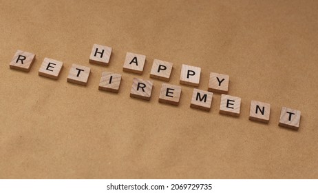 Wooden letters tiles spelling HAPPY RETIREMENT isolated on brown with copy space