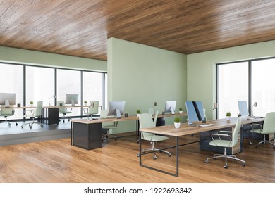 Wooden And Light Green Walls In Office Room With Furniture, Row Of Tables With Computers, Side View. Manager Consulting Room With Modern Furniture And Small Plants, 3D Rendering No People