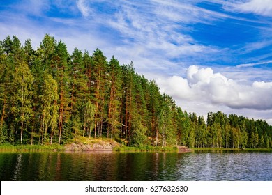 Wooden Log Cabin At The Lake In Summer In Rural Finland