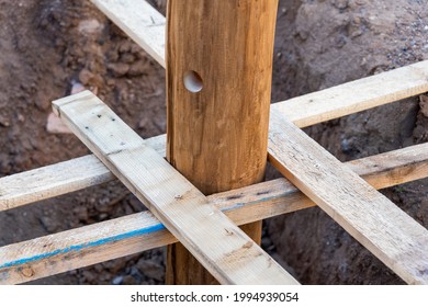 A Wooden Log Fixed With Struts In A Pit, Before Pouring Concrete