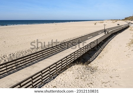 Wooden long promenade along the Baltic Sea coast. Yantarny. Kaliningrad region. Russia