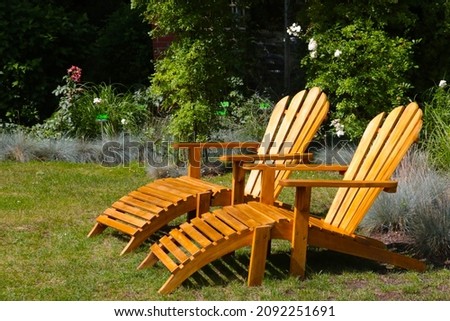 Wooden loungers in the park for relaxation. Full relax. Useful relaxation in the garden, out of focus