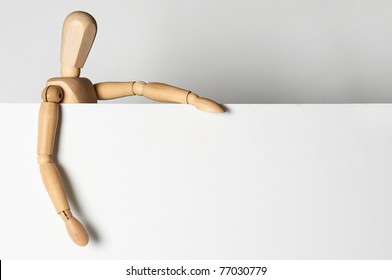 wooden man holding empty white blank banner for your text - Powered by Shutterstock