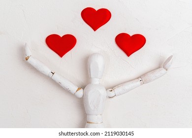 Wooden man mannequin on white background with red heart. Valentines Day or International Day of Charity. Flat lay - Powered by Shutterstock