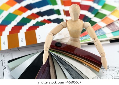 wooden man, a palette of colors designs for interior works, samples of plastics, PVC, for furnishing and architectural drawings houses