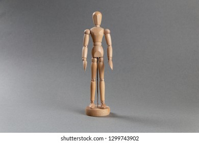Wooden man toy on grey background. - Powered by Shutterstock