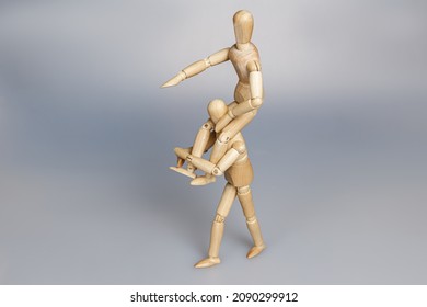 wooden mannequin carrying another one on neck - Shutterstock ID 2090299912