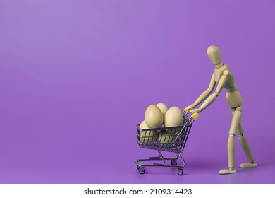 Wooden mannequin carrying shopping cart with chicken eggs on  lilac background. Concept for online shopping and fast delivery of fresh food with copy space. - Powered by Shutterstock