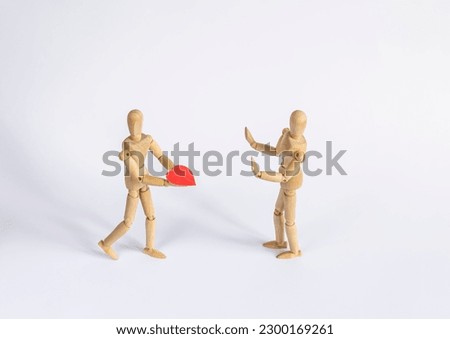 wooden mannequin declaring his love and another one in denial
