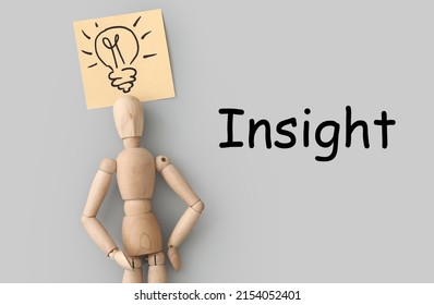 Wooden mannequin with drawn light bulb and INSIGHT on grey background - Powered by Shutterstock