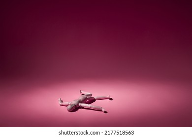 wooden mannequin fell on pink background with copy space - Shutterstock ID 2177518563