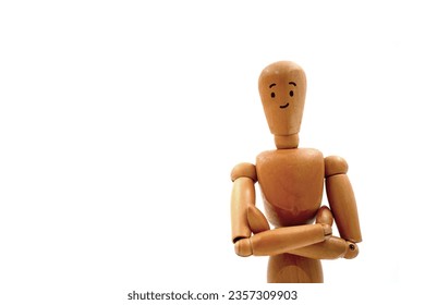 Wooden mannequin figure with arms crossed and smile isolated over white background.