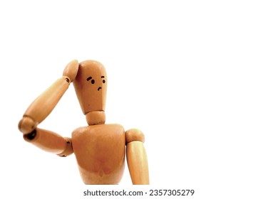 Wooden mannequin figure with having doubts and with confuse face expression on white backgroud.