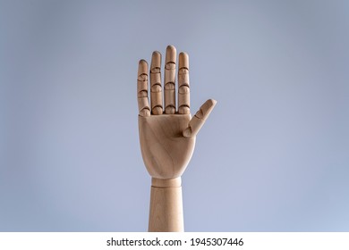 Wooden mannequin hand showing numbers. number five