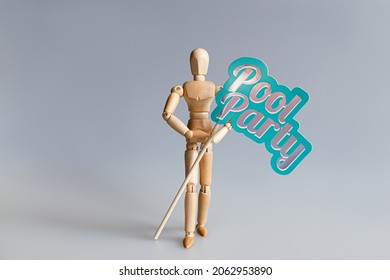 wooden mannequin holding Pool Party sign