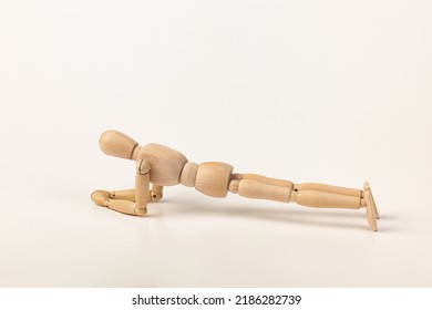 Wooden mannequin or man figurine doing a plank exercise. - Powered by Shutterstock